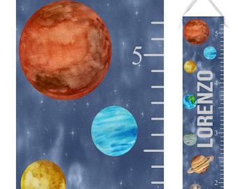 May include: A blue and white growth chart with planets and stars. The chart is labeled with numbers from 2 to 5. The name "LORENZO" is written vertically on the chart.