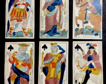 May include: Six playing cards from a vintage deck featuring the King, Queen, and Jack of Spades. The cards are illustrated with colorful figures in elaborate costumes and have the text "T:SERVAES" and "FRANCE." printed on them.
