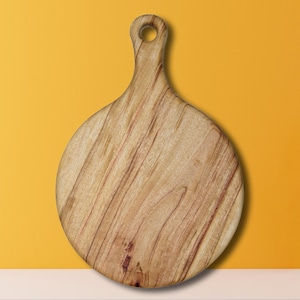 May include: A round wooden cutting board with a handle. The board has a natural wood grain pattern and is light brown in color.