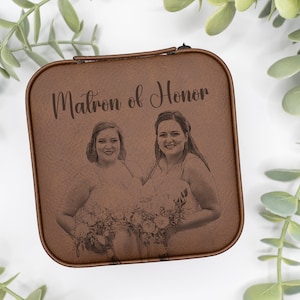 May include: A brown leather box with a photo of two women and the text "Matron of Honor" engraved on the front.