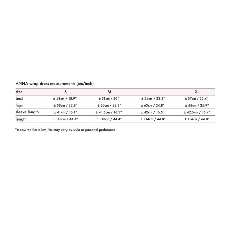 May include: A size chart for a wrap dress in sizes S, M, L, and XL. The chart shows measurements in inches and centimeters for bust, hips, sleeve length, and length. The measurements are taken flat and may vary by style or personal preference.