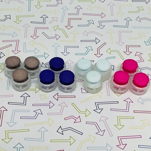May include: Assortment of colourful plastic buttons in grey, blue, white and pink. The buttons have a raised centre and a flat base.