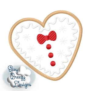 May include: A white heart-shaped gingerbread cookie with red icing and a red bow. The cookie is decorated with white snowflakes.