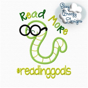 May include: Green worm with black glasses reading a book. The text says "Read More #readinggoals".