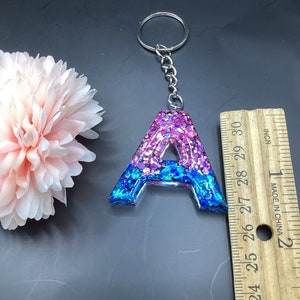 Letter Keychain is 1.5” Sparkling pink and blue chunky glitter