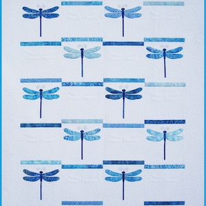 May include: A white quilt with a blue and white patterned design featuring multiple blue dragonfly shapes.