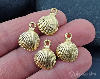 May include: Four gold-colored metal seashell charms with a loop for attaching to jewelry or other crafts.