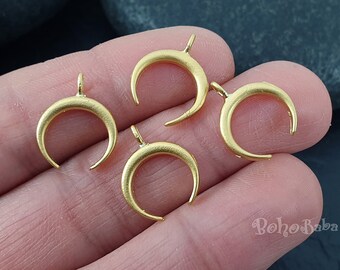 May include: Four gold-toned crescent moon charms with a loop at the top for attaching to jewelry or other crafts.