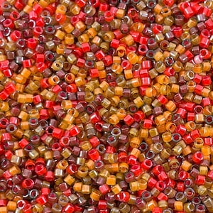 May include: A close-up image of a large quantity of small, round, seed beads in shades of red, orange, brown, and gold. The beads are arranged in a random pattern, creating a colorful and textured background.