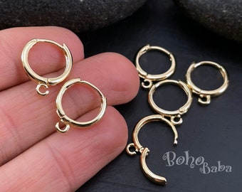 May include: Gold-toned hoop earring findings with a jump ring. The findings are on a hand and a black surface.  The text "boho baba" is visible in the image.