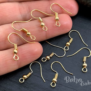 May include: Gold-toned earring hooks with a spring-loaded closure. The hooks are made of metal and have a smooth finish.