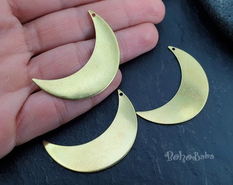 May include: Three gold-toned metal crescent moon charms. The charms are approximately 2 inches in length.