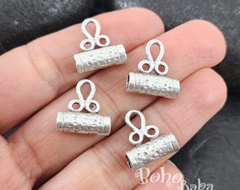May include: Four silver-toned metal toggle clasps with a hammered texture. Each clasp has a loop at the top and a cylindrical barrel.