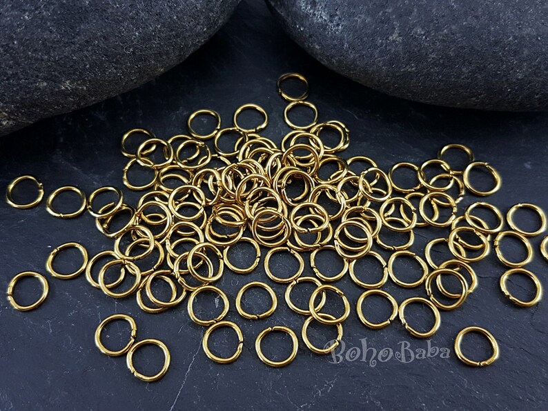 May include: A large pile of gold jump rings, perfect for jewelry making or crafting projects.