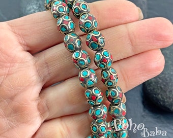 May include: Two strands of beaded bracelets with turquoise and red accents. The beads are round and have a gold-toned metal finish. The bracelets are stacked on top of each other.