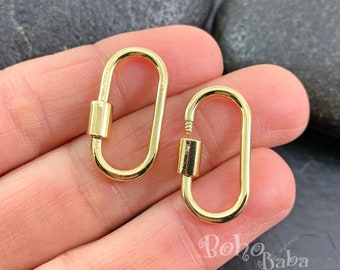 May include: Two gold-toned oval-shaped lobster clasps. The clasps are about 1 inch long and have a shiny finish.