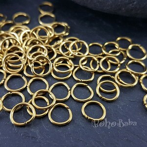 May include: A large pile of gold jump rings. The rings are small and round, and they are perfect for jewelry making.