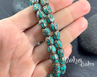 May include: Two strands of turquoise and gold beads. The beads are oval shaped and have a decorative pattern. The beads are strung on a cord and are ready to be made into a necklace or bracelet.