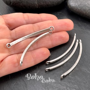 May include: Five silver-toned metal curved bar connectors, each featuring a small circular loop at both ends. The bars have a smooth, slightly weathered finish. The text Boho Baba is printed in white in the lower portion of the image.