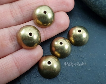 May include: Five gold-colored metal dome-shaped beads with a small hole in the center of each bead.