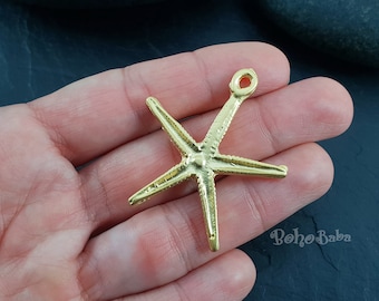 May include: Gold-toned metal starfish charm with a loop at the top for attaching to jewellery or other crafts.