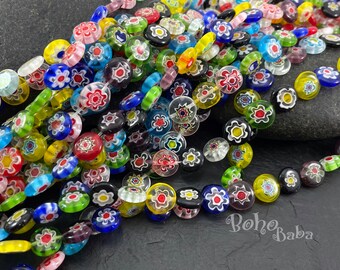 May include: A strand of colorful glass beads with a floral pattern. The beads are round and flat, and they are strung on a clear thread. The beads are a variety of colors, including red, green, blue, yellow, and white.