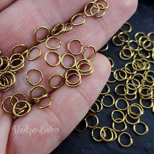 May include: A large quantity of small, gold-colored jump rings. The rings are about 6mm in diameter and are perfect for jewelry making.