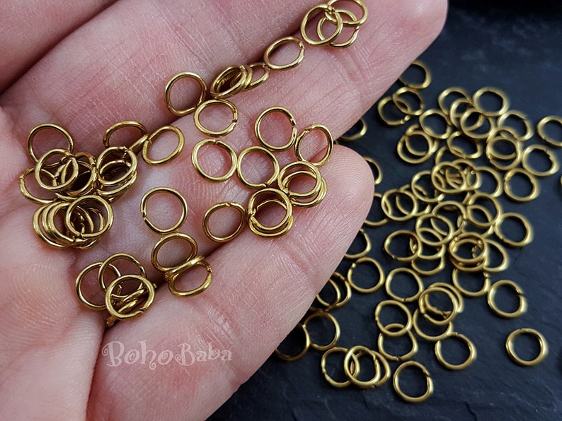 May include: A large quantity of small, gold-colored jump rings. The rings are about 6mm in diameter and are perfect for jewelry making.