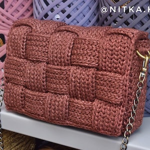 May include: A brown knitted crossbody bag with a silver chain strap and a gold clasp. The bag has a woven texture and a sparkly finish.