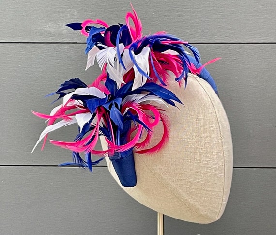 Blue ribbon-wrapped headband with blue, white, and magenta feather sprays