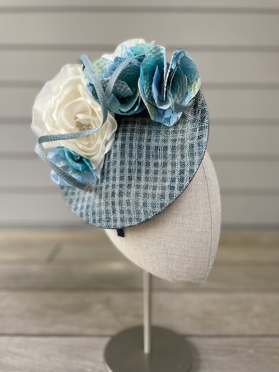 Turquoise windowpane sinamay straw saucer hat with white silk roses, ombré tinted petals, and sinamay curls