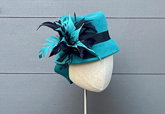 Turquoise velour felt mini perching fedora with black ribbon band and handmade feather spray ornament