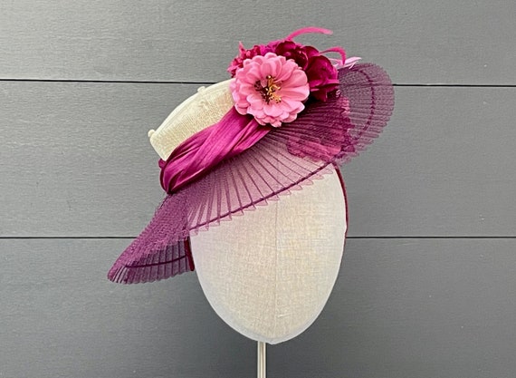 Knotted straw and pleated crinoline brimmed hat on headband with silk zinnias and curled coq feathers