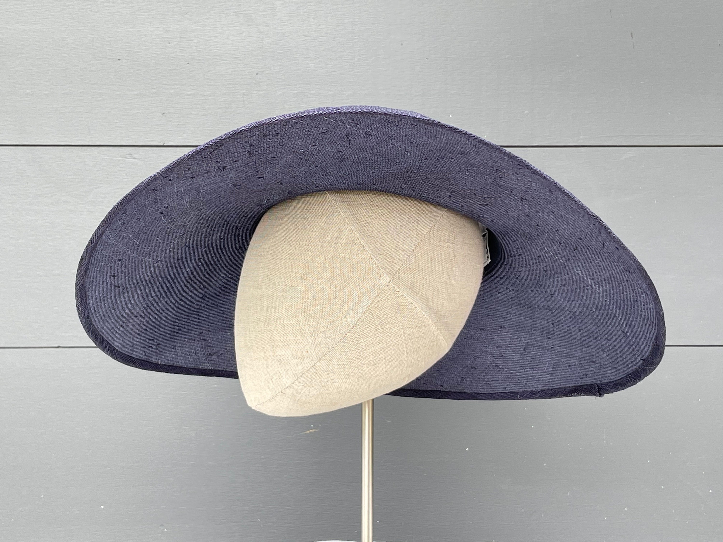 Wide-brimmed navy straw hat with handmade silk flowers and