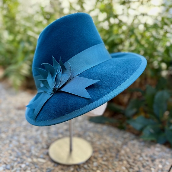Turquoise velour felt asymmetrical brimmed hat with cut ribbon ornament