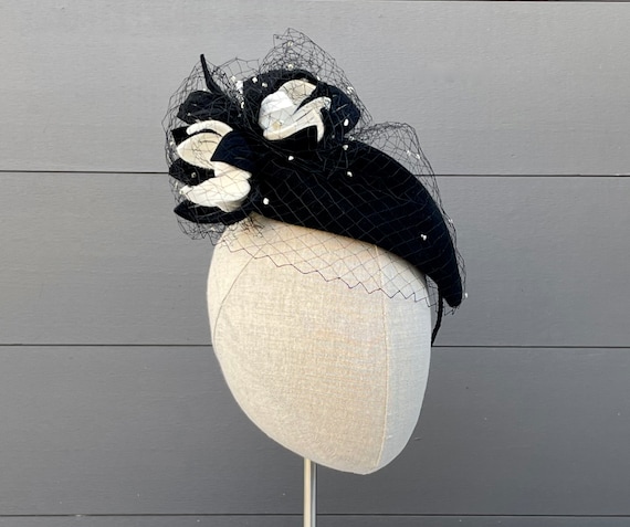 Black velour felt cocktail hat with black and off-white felt flowers, freshwater pearls, and vintage dot veiling