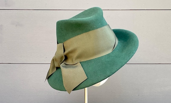Forest green velour felt fedora with asymmetrical brim and wide olive green vintage ribbon band and bow