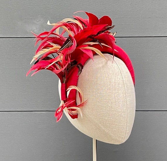 Red ribbon-wrapped headband with red, beige, and pheasant feather spray