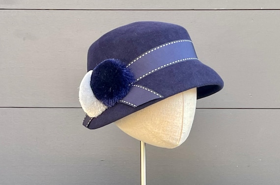 Navy velour felt asymmetrical cloche with vintage pompoms and navy and white dash ribbon band