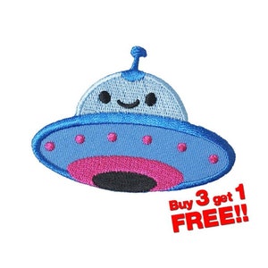 May include: Blue and pink embroidered iron-on patch of a cartoon UFO with a smiling face. The patch has the text "Buy 3 get 1 FREE!!" in red.