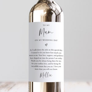 May include: A white wine bottle label with a wedding-themed message for a mother. The label reads "To My Mum On My Wedding Day" with a heart symbol. The message continues with a heartfelt note expressing gratitude and love for the mother. The label is signed "Millie".