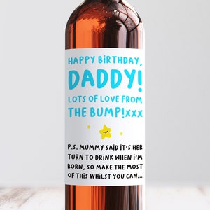 May include: A white wine bottle label with blue and yellow text that reads "Happy Birthday, Daddy! Lots of love from the bump!xxx" and "P.S. Mummy said it's her turn to drink when I'm born, so make the most of this whilst you can..."