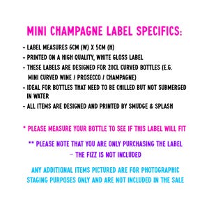 May include: A white informational sign with pink, purple, and blue text detailing mini champagne label specifics. The text states the labels measure 6cm by 5cm, are printed on white gloss material, and are designed for 20cl curved bottles.