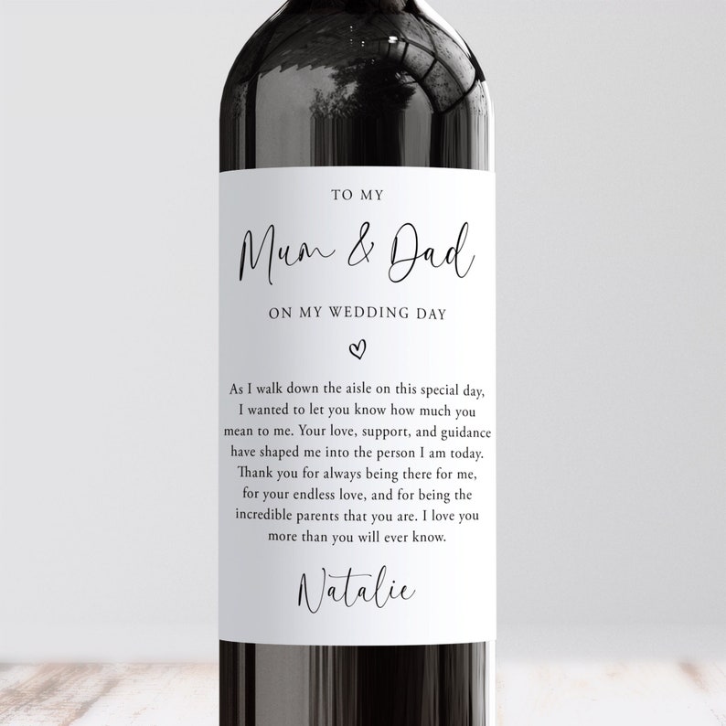 May include: A white wine bottle label with a black and white design. The label reads "To My Mum & Dad On My Wedding Day." The label also includes a short message from the bride to her parents.