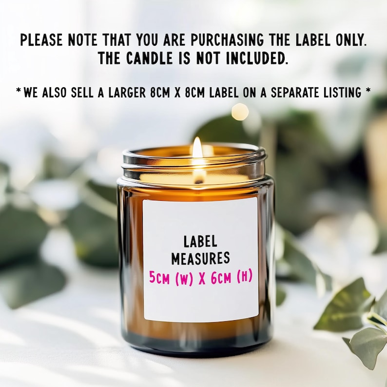 May include: A lit candle in a clear glass jar with a white label. The label reads "LABEL MEASURES 5cm (W) X 6cm (H)". The text above the label states that the candle is not included and that the label is for sale.