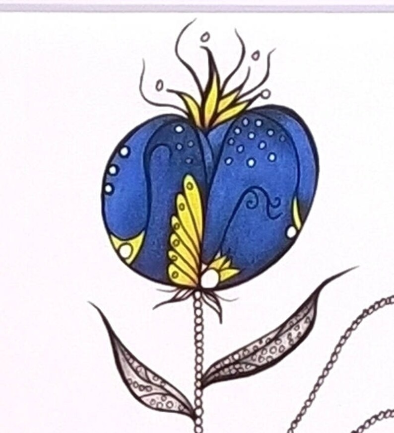 May include: A blue and yellow abstract flower with a black outline. The flower has a round center with a yellow and white design. The stem is black with a white beaded design and two leaves with a black and white pattern.