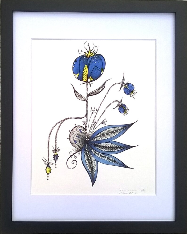 May include: A framed black and white ink drawing of a stylized blue flower with yellow accents. The drawing is on white paper and is signed "Joanie Jones" in the bottom right corner.
