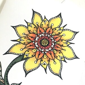 May include: A yellow and orange mandala sunflower with black outlines and white dots. The sunflower has a green stem.
