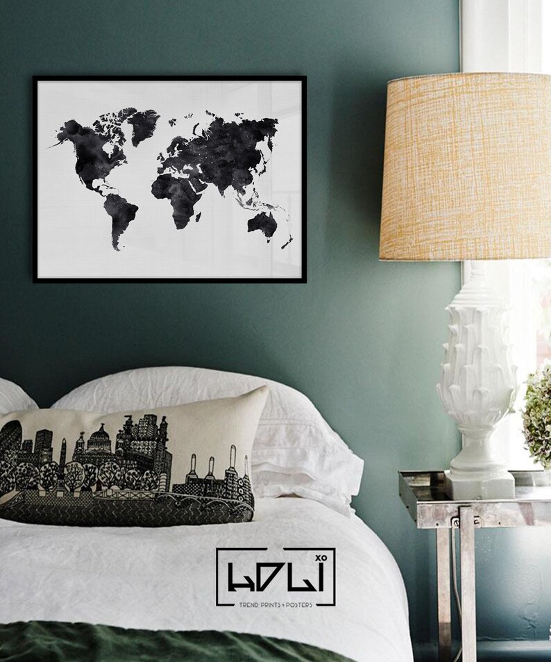 Puede incluir: Impresi&oacute;n de un mapa del mundo en blanco y negro en un marco negro que cuelga de una pared verde azulada sobre una cama blanca con una almohada en blanco y negro que representa un horizonte urbano. La cama tiene un edred&oacute;n blanco y una manta verde. Una l&aacute;mpara blanca con una pantalla beige se encuentra sobre una mesita de noche plateada.