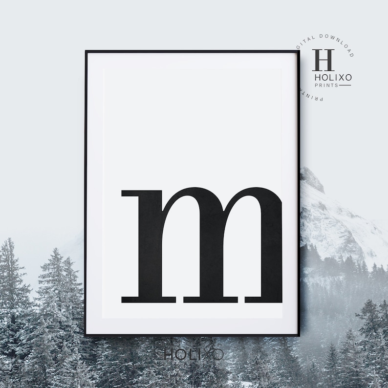 May include: Black and white printable wall art featuring the letter "m" in a bold, sans-serif font. The letter is centered on a white background within a black frame.